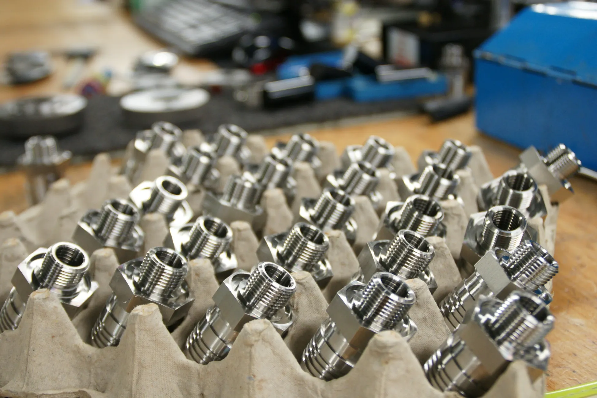 Trays of precision-machined metal fittings