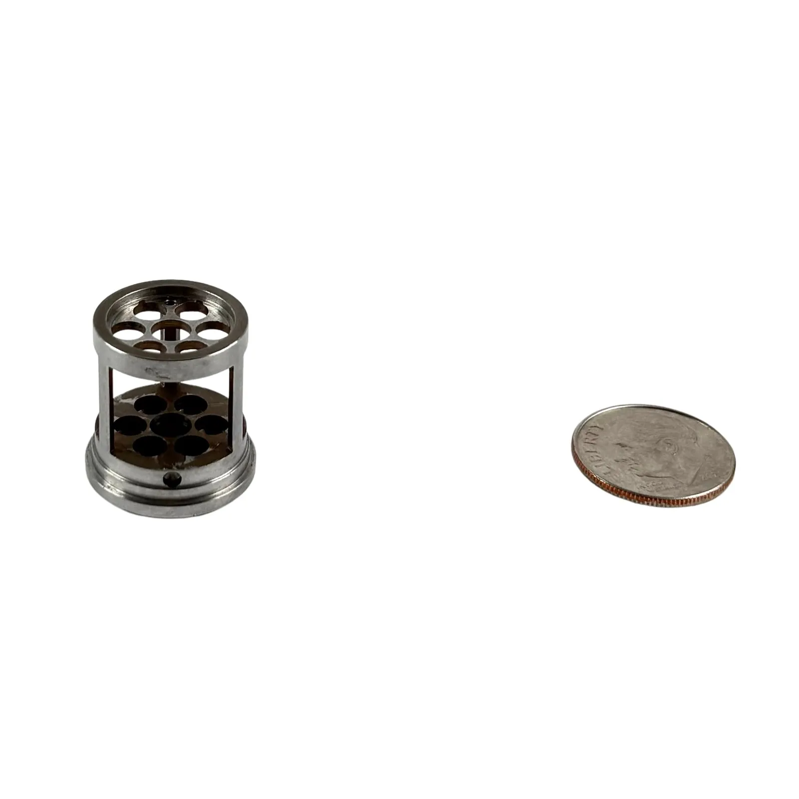 An open-frame stainless steel cage / retainer with perforated end discs — intricate multi-axis machining
