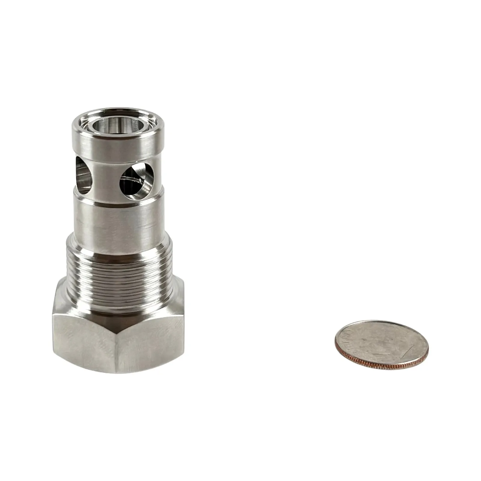 A turned stainless steel cartridge with a hex base, external threads, and cross-drilled ports