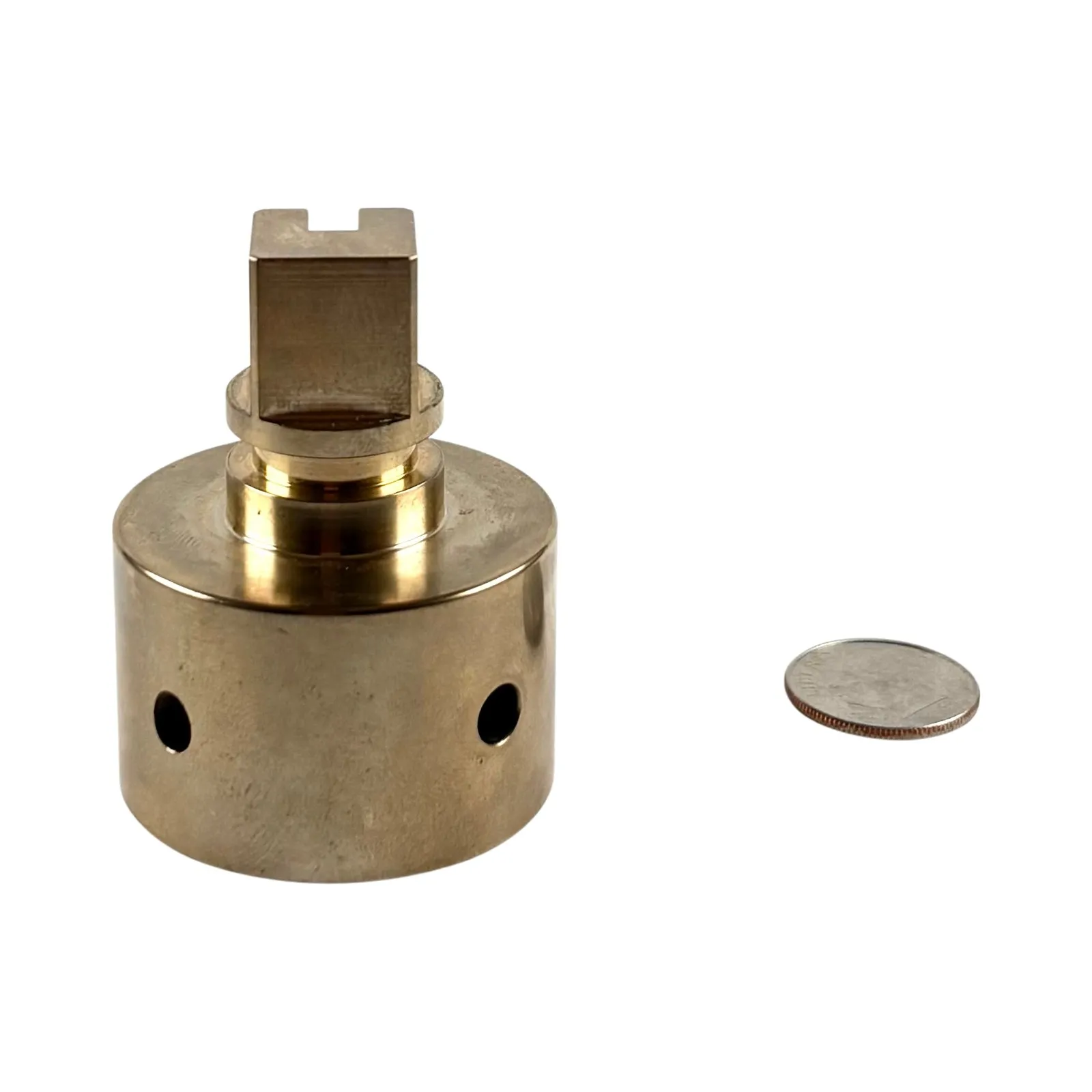 A turned brass valve body with a slotted square drive boss, turned collar, and cross-drilled side ports