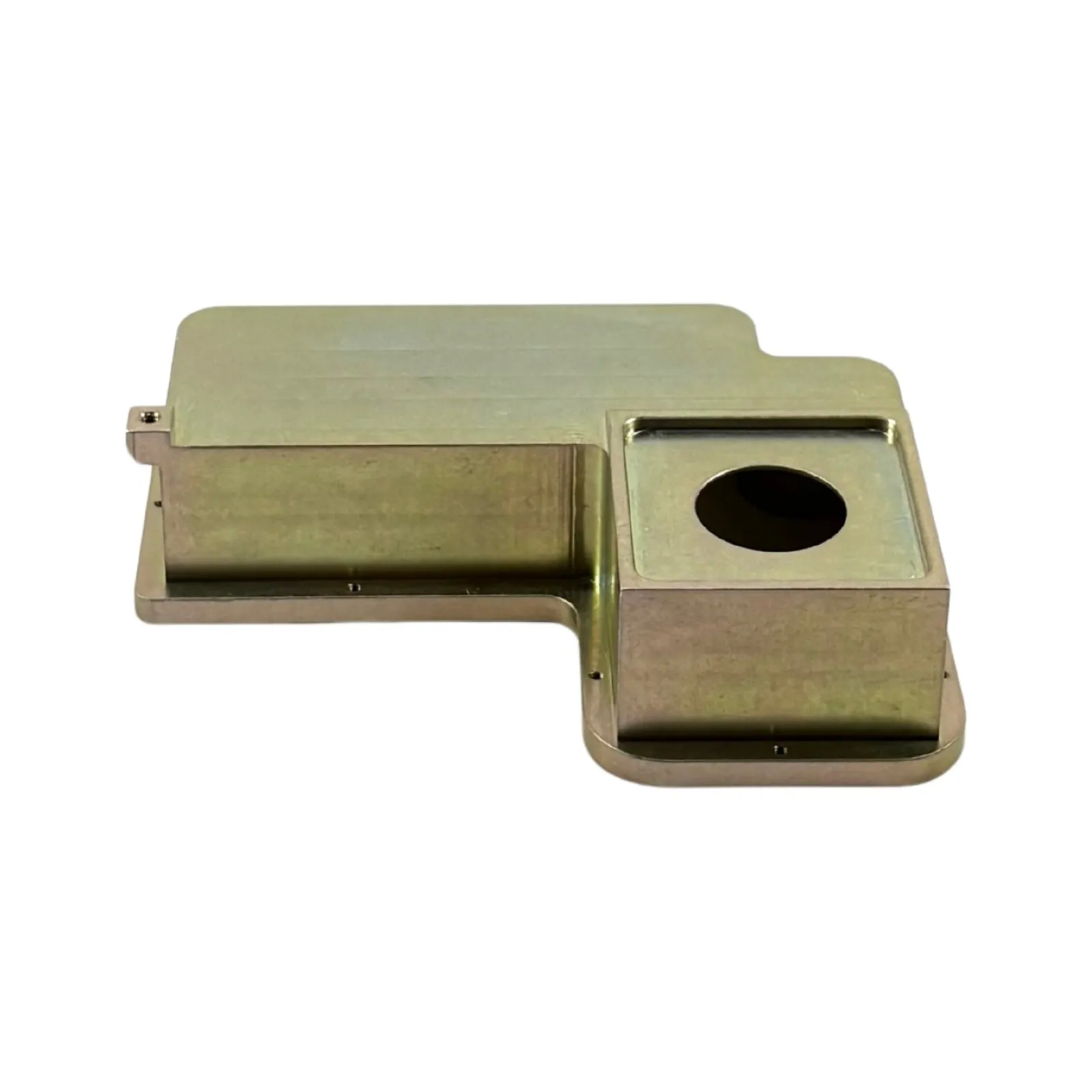 A yellow-chromate-finished milled steel housing with a stepped pocket and round bore
