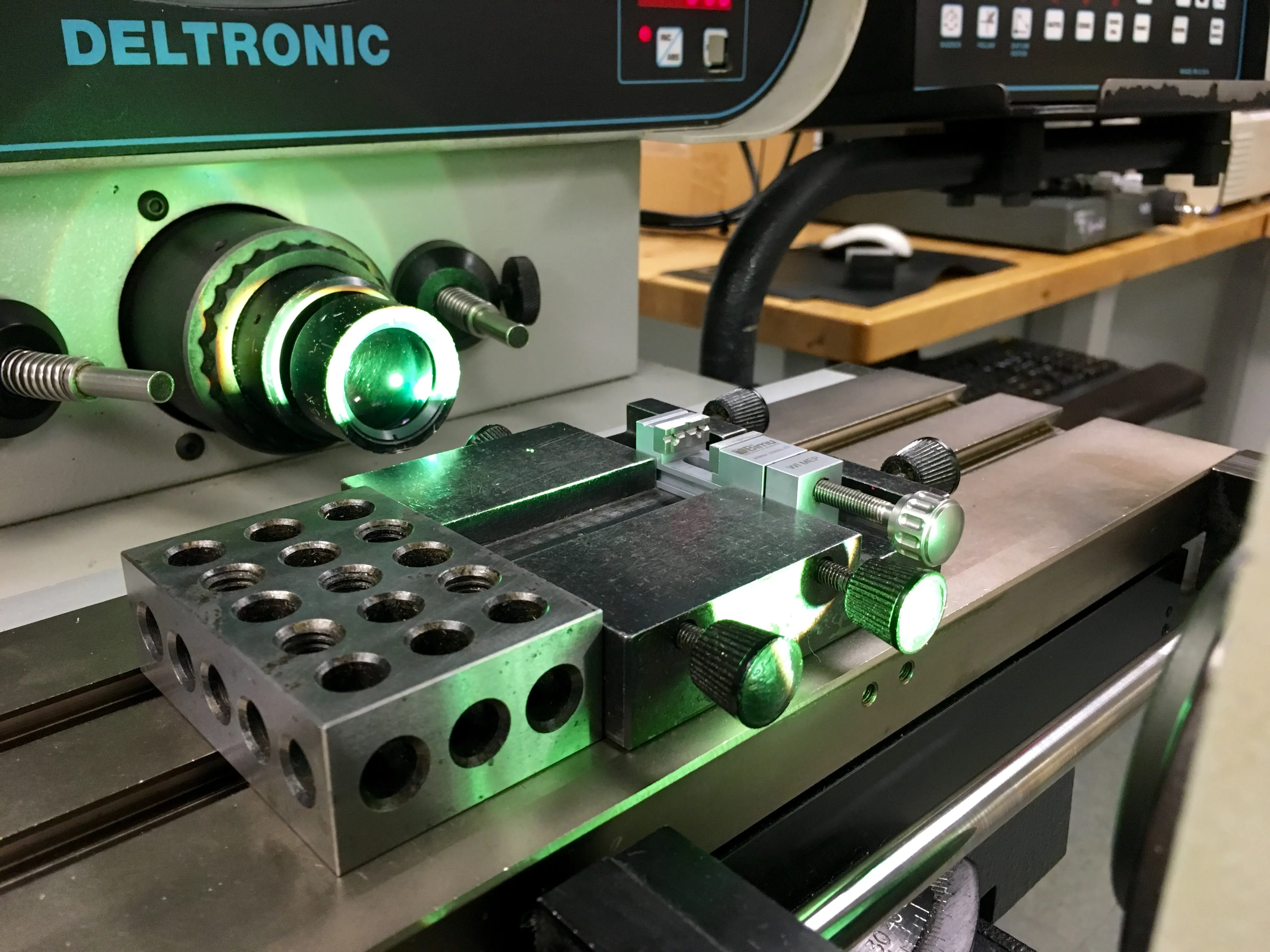 Part fixtured on the stage of a Deltronic optical comparator in the quality lab